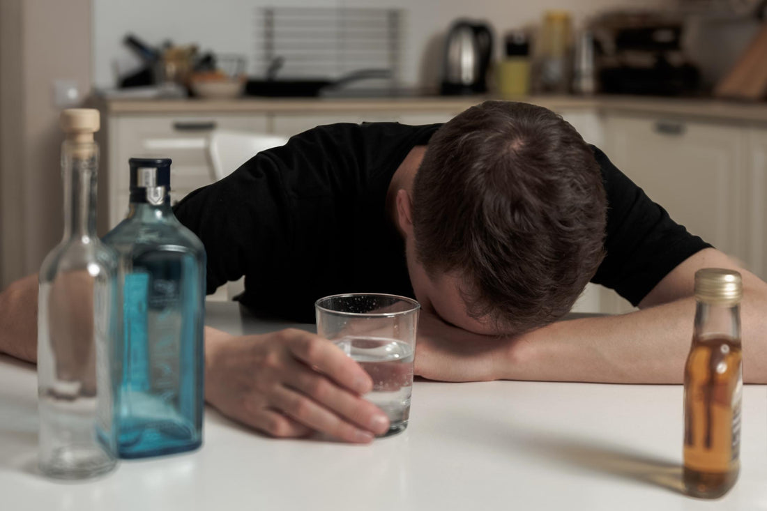 Hungover man drinking water.