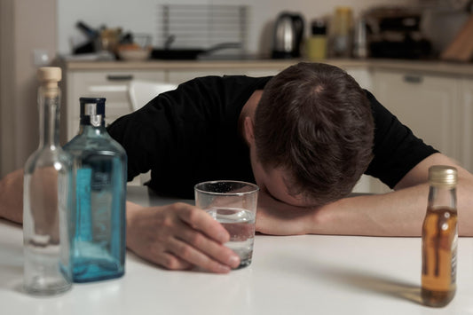 Hungover man drinking water.
